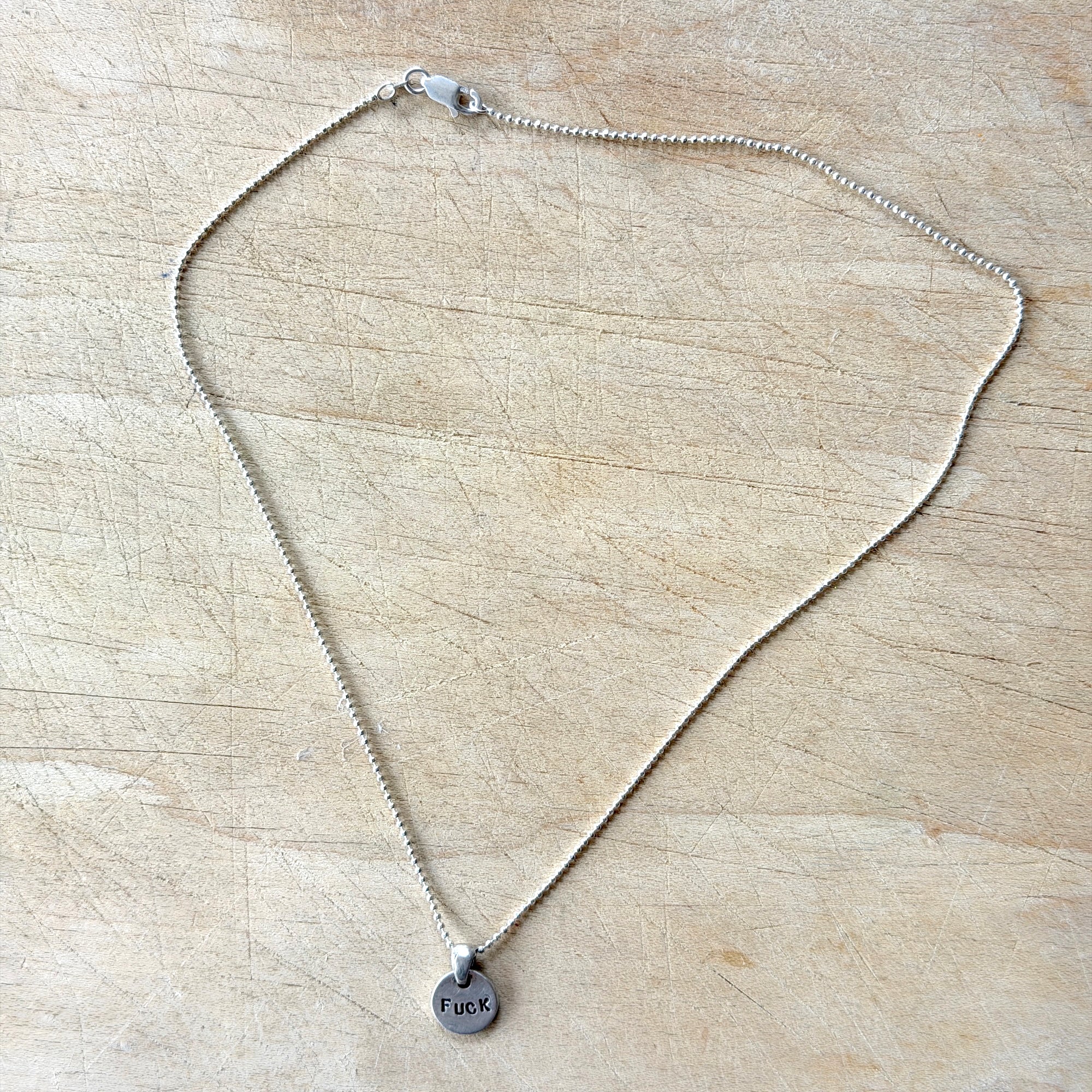 Silver Brass Skull Joder Hielo Necklace, by Margaret Sullivan at